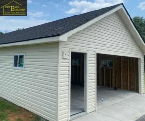 showing the open garage bay and open side service door before final door installations, referencing garage builder