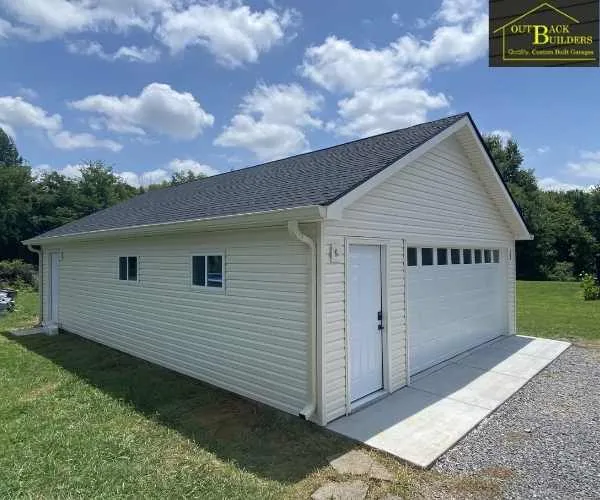 showing the open garage bay and open side service door before final door installations, referencing garage builder
