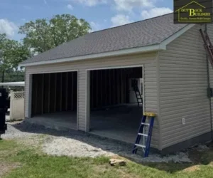 an asphalt shingle roof, and open garage bays, built by a garage builder
